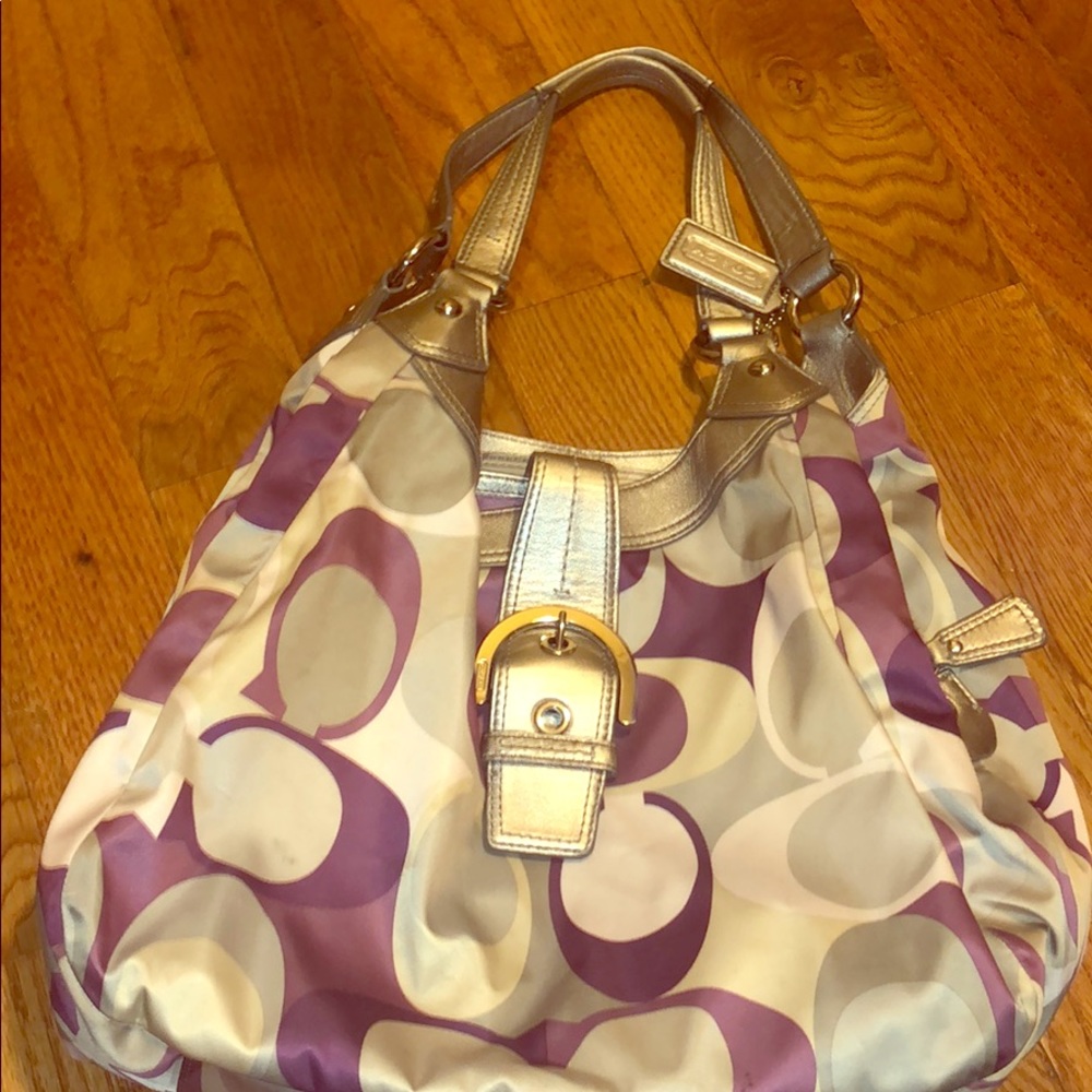 Signature pattern grey and purple coach purse.